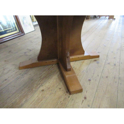 12 - A Robert 'Mouseman' Thompson of Kilburn oak circular dining table, with adze top, width 57ins, heigh... 