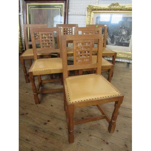 13 - A Robert 'Mouseman' Thompson of Kilburn set of six oak lattice back dining chairs,