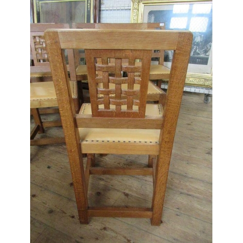 13 - A Robert 'Mouseman' Thompson of Kilburn set of six oak lattice back dining chairs,