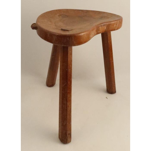 16 - A Robert Mouseman Thompson three legged stool, with shaped seat and chamfered legs, height 14ins