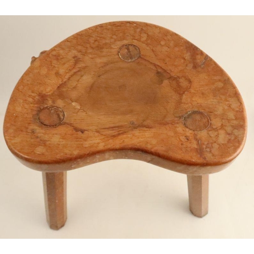 16 - A Robert Mouseman Thompson three legged stool, with shaped seat and chamfered legs, height 14ins