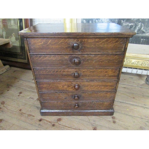 25 - A  small 19th century faux bois painted pine chest of drawers, with oak graining, width 23.5ins, dep... 