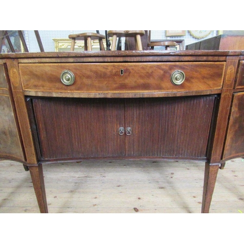 26 - A late Georgian mahogany sideboard, having tambour sliding doors, flanked by cellarette drawer and a... 