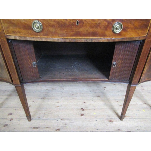 26 - A late Georgian mahogany sideboard, having tambour sliding doors, flanked by cellarette drawer and a... 