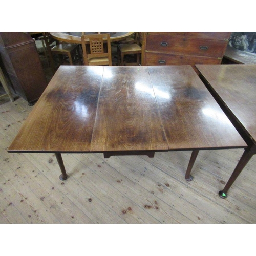 35 - A 19th century mahogany extending gate leg dining table, made up of two sections, raised on turned l... 