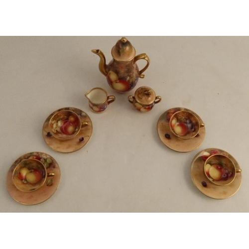 385 - A Royal Worcester miniature coffee set, consisting of coffee pot, sugar box and cover, milk jug and ... 