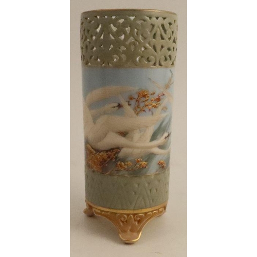 386 - A Royal Worcester cylindrical vase, with open fret work top, painted with swans in flight to a powde... 