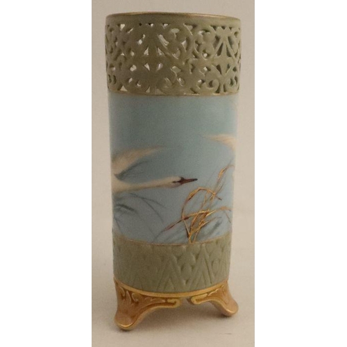 386 - A Royal Worcester cylindrical vase, with open fret work top, painted with swans in flight to a powde... 