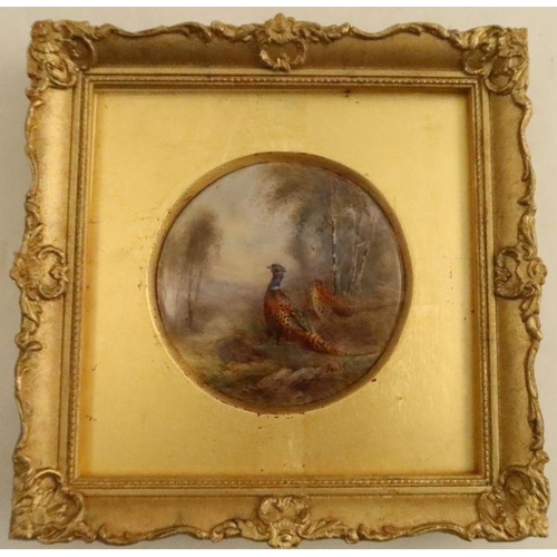 392 - A framed Royal Worcester circular plaque, painted with pheasants in landscape by Jas Stinton - There... 