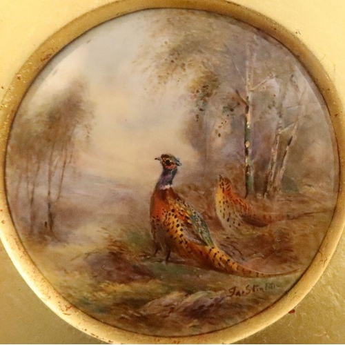 392 - A framed Royal Worcester circular plaque, painted with pheasants in landscape by Jas Stinton - There... 