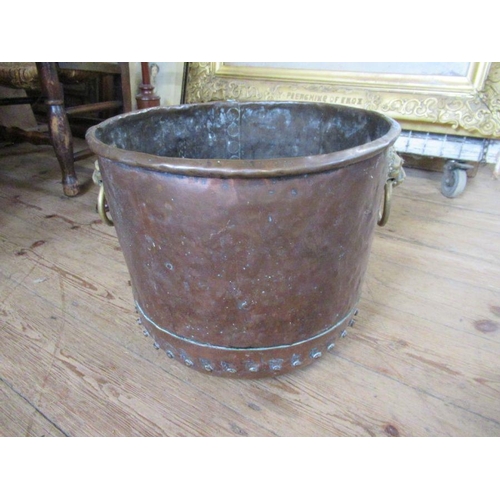 42 - An Antique copper and brass log bin, with lion mask handles, width 16ins, height 13ins