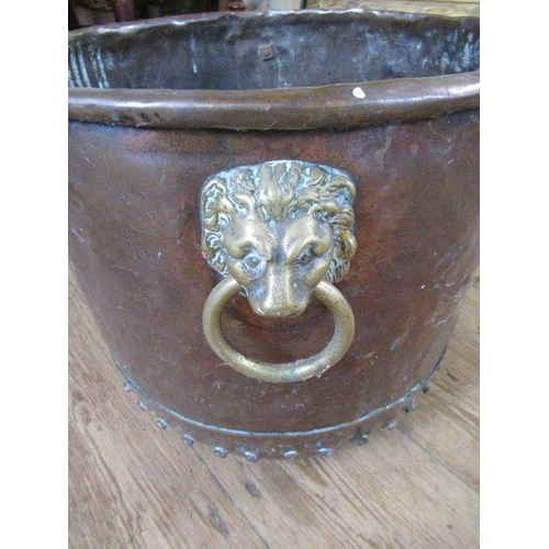 42 - An Antique copper and brass log bin, with lion mask handles, width 16ins, height 13ins