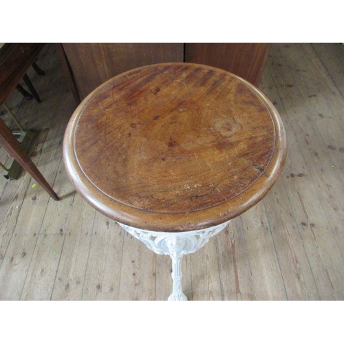 46 - A 19th century pub table, with a solid mahogany top with unusual design masks and heavy cast iron ba... 