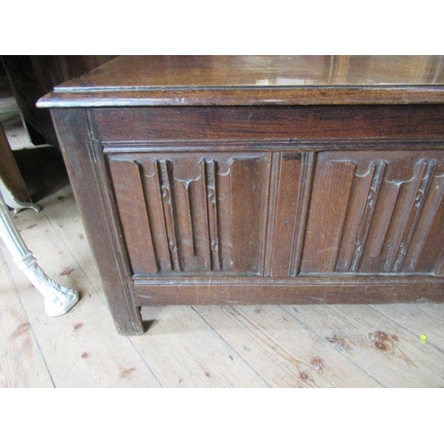 56 - An Antique oak coffer, having four carved fielded panels to the front, width 57ins, depth 17ins