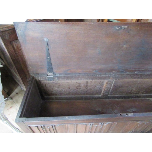 56 - An Antique oak coffer, having four carved fielded panels to the front, width 57ins, depth 17ins