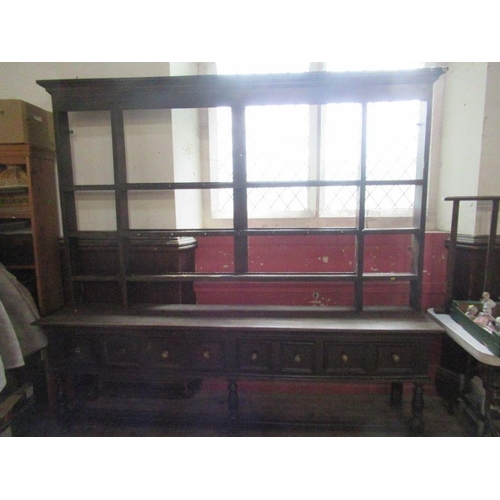 58 - A large Antique oak dresser, having a plate rack over the dresser base, fitted with four short drawe... 