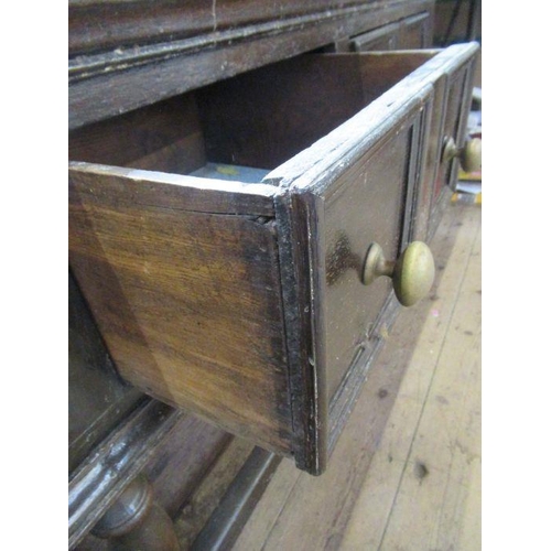 58 - A large Antique oak dresser, having a plate rack over the dresser base, fitted with four short drawe... 