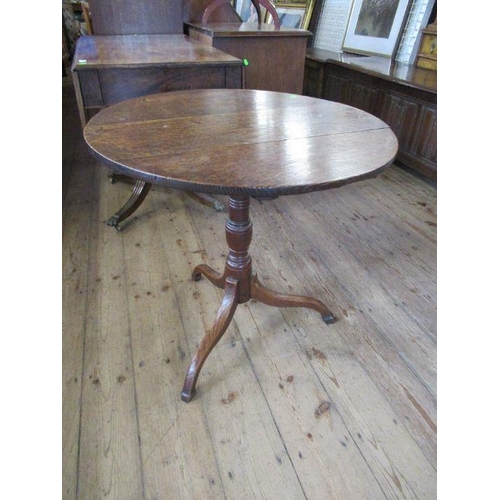 60 - A 19th century oak tripod table, diameter 26ins, height 27ins