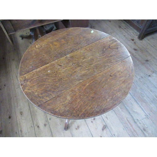 60 - A 19th century oak tripod table, diameter 26ins, height 27ins