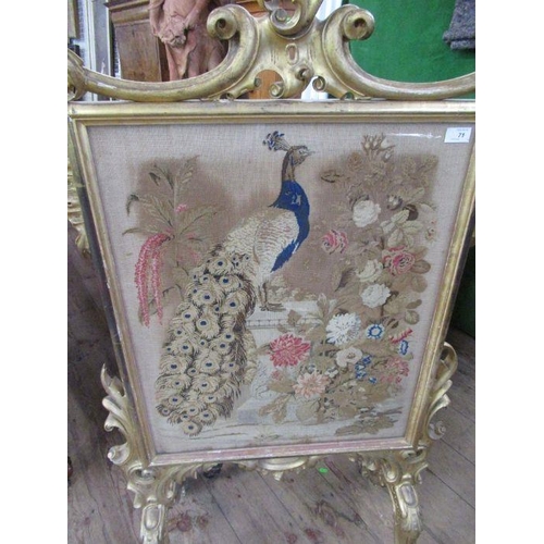 71 - A 19th century gilt framed fire screen, the tapestry panel decorated with a peacock within a landsca... 