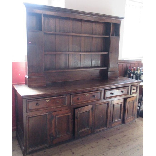 1 - A large Antique dresser, with close boarded rack bask, having a pair of cupboards, the base fitted w... 