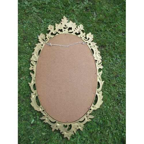 133 - A modern gilt framed mirror, with ornate mirror, 25ins x 16ins