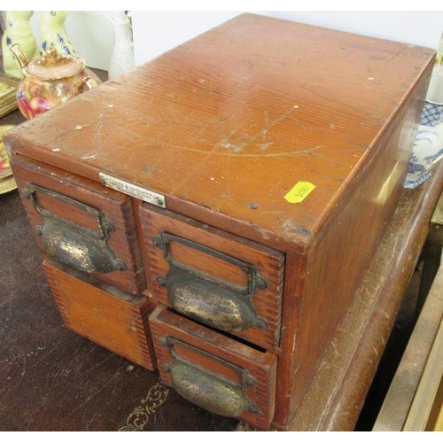 173 - A wooden four drawer filing box, containing a collection of glass magic lantern slides