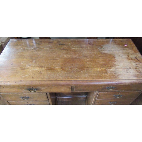 18 - An Antique pine desk, fitted with a cupboard to the kneehole and an arrangement of nine drawers, 51.... 