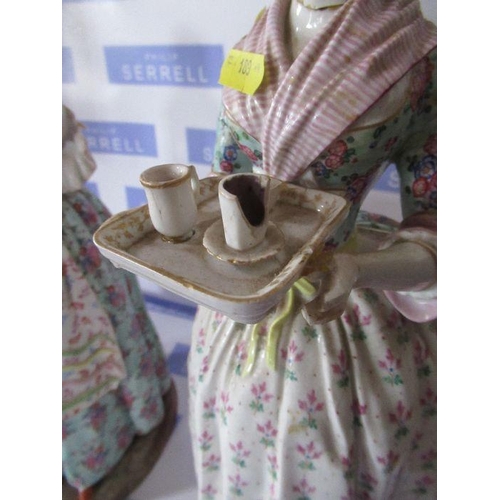 189 - A pair of German porcelain figures, of girls, one serving the other presenting a letter, crossed swo... 