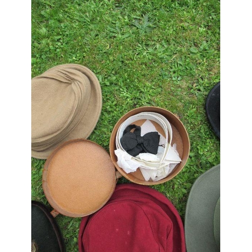 211 - A collection of hats, including bowler, vintage children's riding hats, a Herbert Johnson hat box an... 