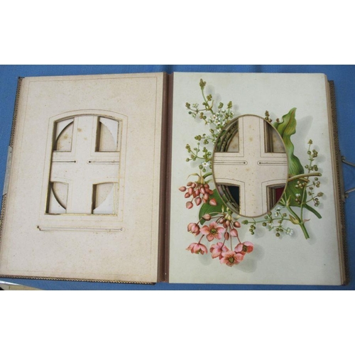 298 - A Victorian photograph album, with embossed leather cover and flowers to some pages