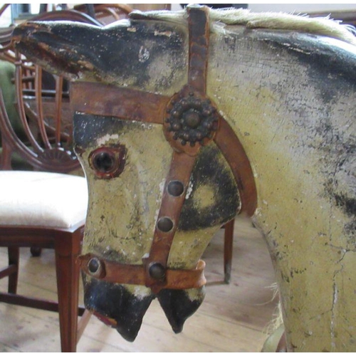 30 - An Antique painted wooden rocking horse, with remains of leather tack, on a pine base, height 32ins,... 