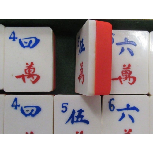 303 - A cased mah jong set, with plastic tiles, together with a travelling backgammon game