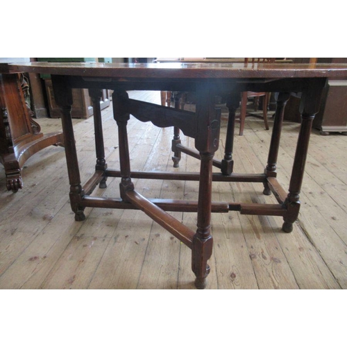 51 - An Antique oak gateleg table, diameter 54.5ins, height 28ins