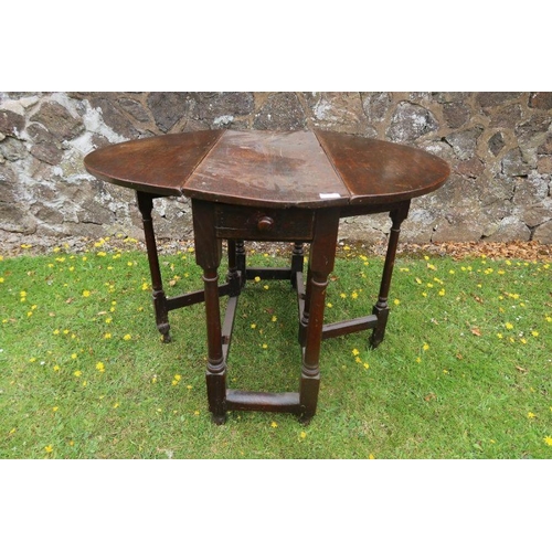 63 - An antique oak gate leg table width 35ins, length 40.5ins, height 28ins