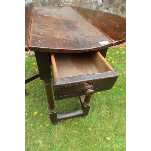 63 - An antique oak gate leg table width 35ins, length 40.5ins, height 28ins