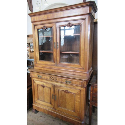 7 - A 19th century French walnut cabinet, the upper section having a pair of glazed doors revealing shel... 