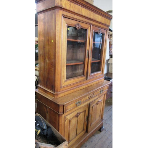 7 - A 19th century French walnut cabinet, the upper section having a pair of glazed doors revealing shel... 