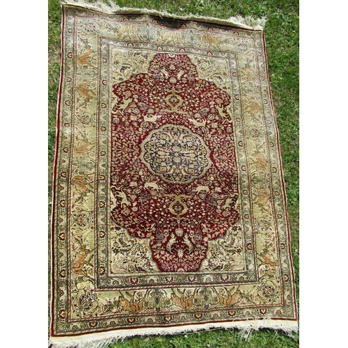 71 - A silk rug, decorated with animals, 54ins x 39ins