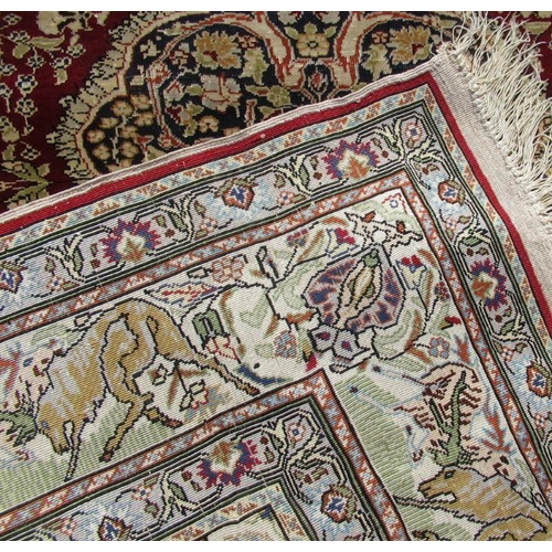 71 - A silk rug, decorated with animals, 54ins x 39ins