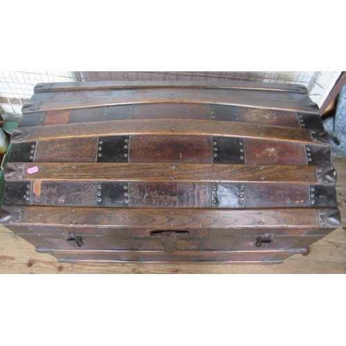 89 - A vintage dome topped trunk, with wood and metal bands, having a fitted interior, width 31ins, heigh... 