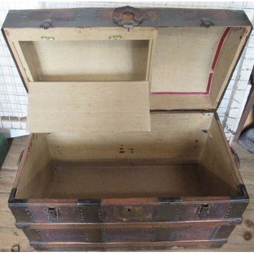 89 - A vintage dome topped trunk, with wood and metal bands, having a fitted interior, width 31ins, heigh... 