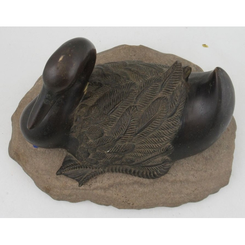 257 - A bronze model, of a duck, on a stone base, width 15ins