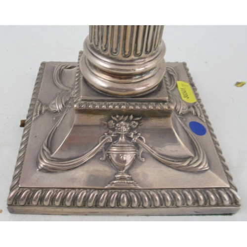 280 - A silver oil lamp, with cut glass reserve on a Corinthian column, the square base decorated with urn... 