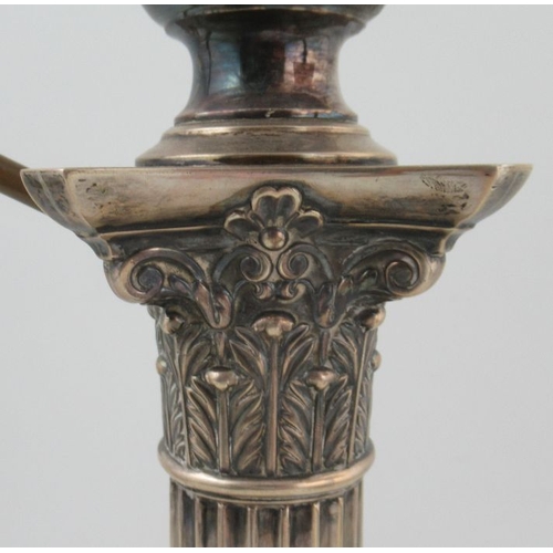 280 - A silver oil lamp, with cut glass reserve on a Corinthian column, the square base decorated with urn... 