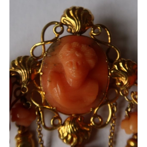 303 - A 19th century Italian carved coral and gold pendant brooch, having oval carved coral bust portrait,... 