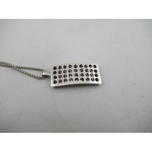 311 - A white gold and diamond pendant, with necklace chain, the chain stamped 750, the pendant made up of... 