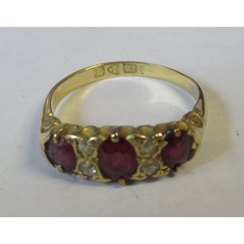 329 - An 18ct three stone ruby ring, 2.9g, two pairs of old cut diamonds,