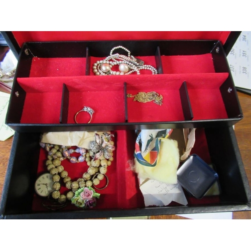 331 - A collection of costume jewellery, including simulated pearls etc in leather suitcase