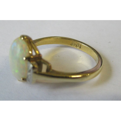 333 - An 18ct opal and diamond ring, the central oval cabochon, with four old cut diamonds to the shoulder... 